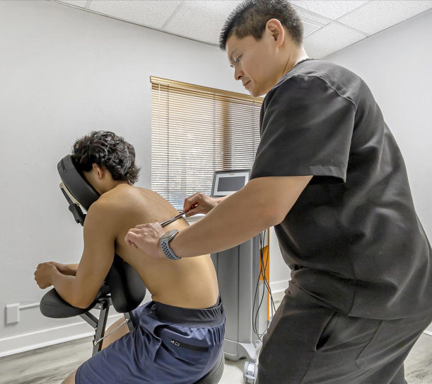 Physical therapist providing hands-on manual therapy to a patient